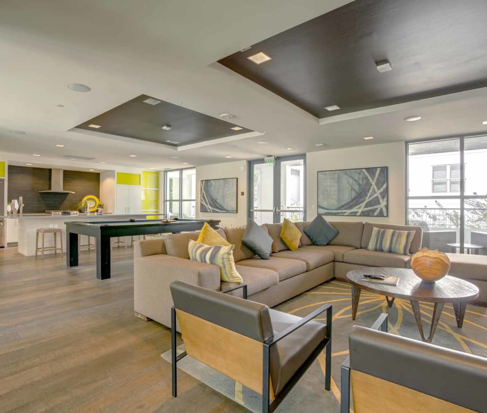 Resident clubhouse with bar seating and a billiards table at Domus on the Boulevard in Mountain View, California