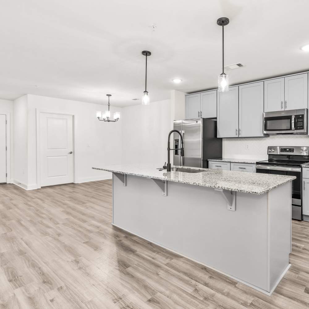 Open kitchen connecting to living room at Aspire at Old Guard in Columbus, Georgia