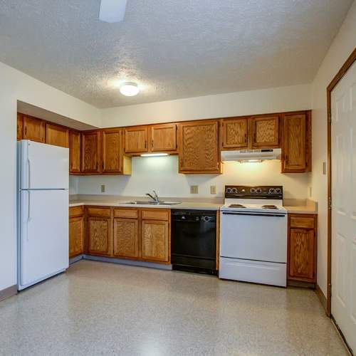 Kitchen with wooden cabinets and appliances at Wellington Place in Ottawa, Ohio