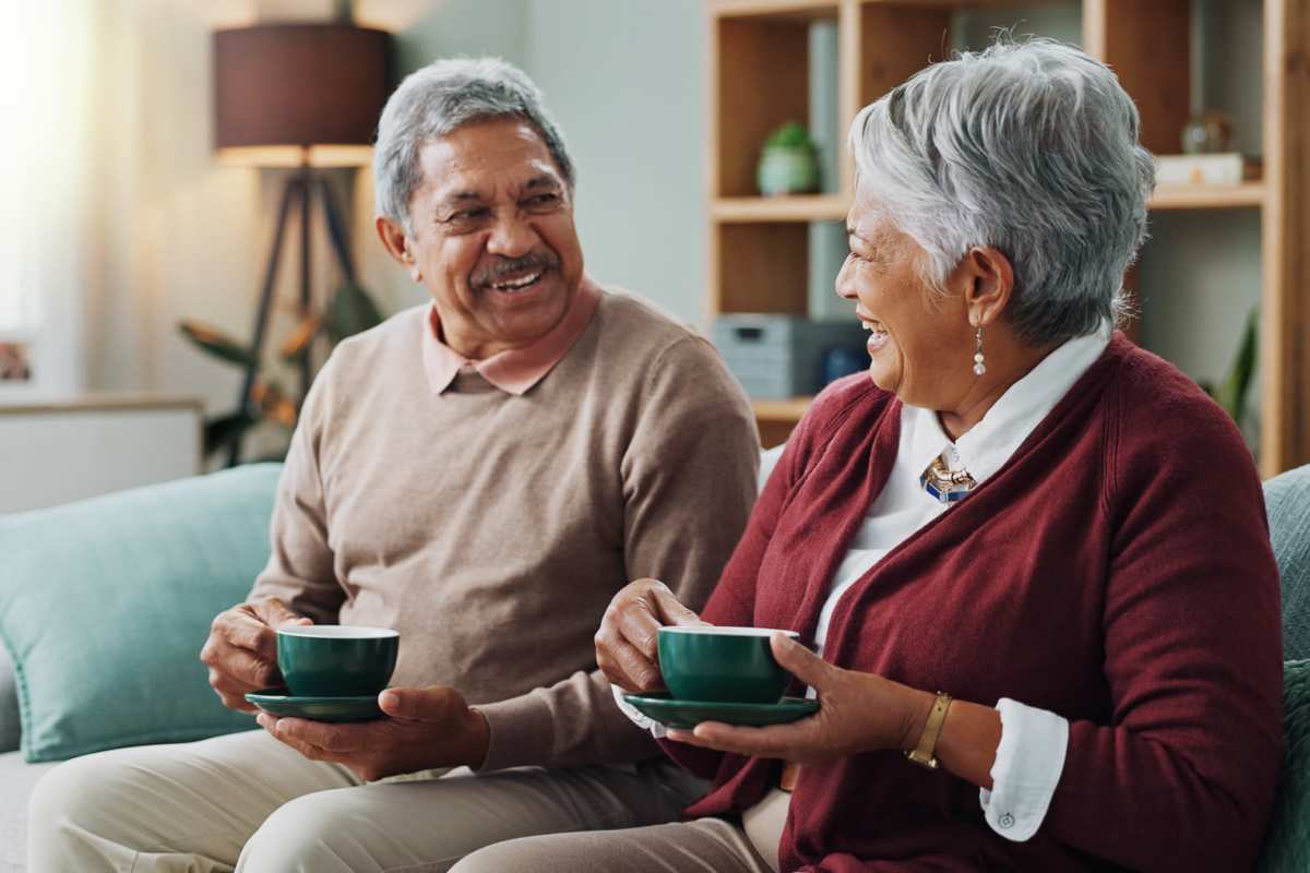 Cozy living room with two people enjoying tea together at Villas At Alexander Bay in Baytown, Texas 