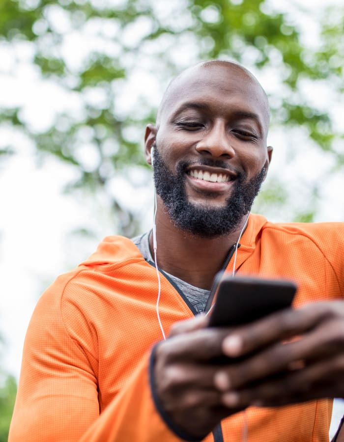 resident smiling on his phone at The Lodge at Napa Junction in American Canyon, California