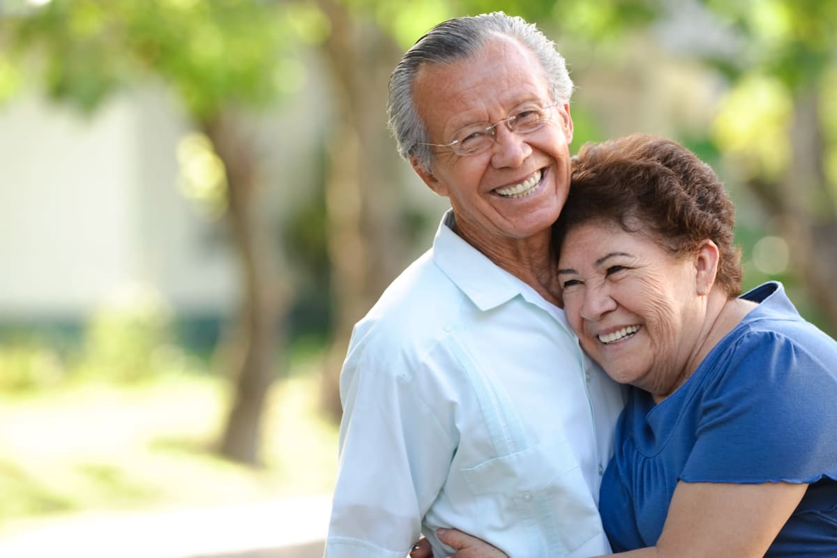 Resident couple walking over a bridge in a park near Almond Heights in Orangevale, California