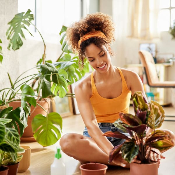 A woman potting plants in her home at Station 21 Apartments in Mesa, Arizona