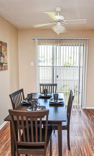 Dining area with faux wood floors and sliding door access to a private patio at River Ranch in Sherman, Texas