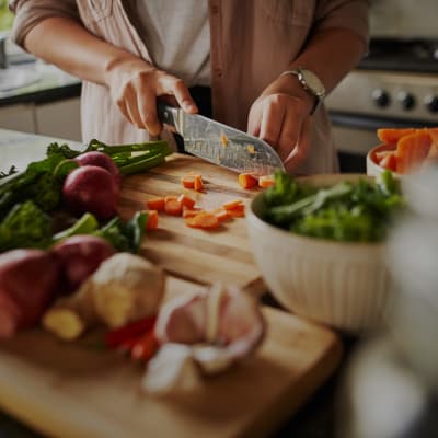 A resident preparing food in a kitchen in a home at Beachwood North in Joint Base Lewis McChord, Washington