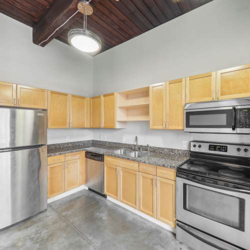 Kitchen with dishwasher at Stadium Loft Apartments in Saint Louis, Missouri