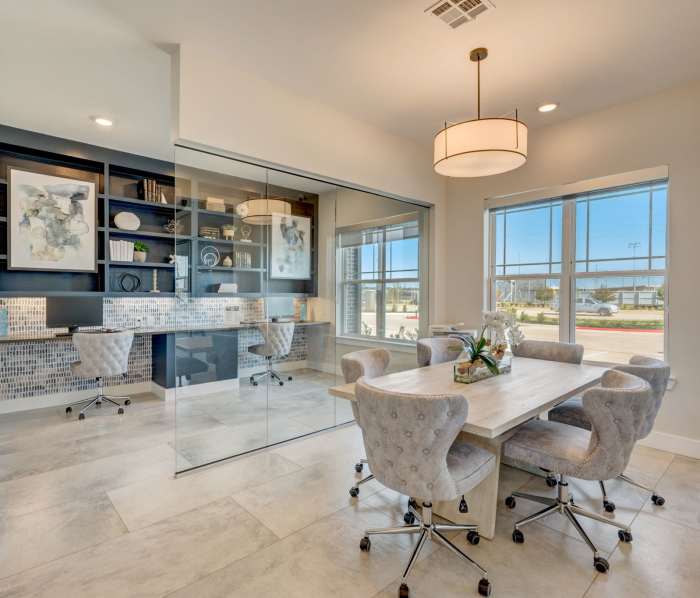 Clubhouse with workstation and book shelves at Skyview Flats in Cypress, Texas