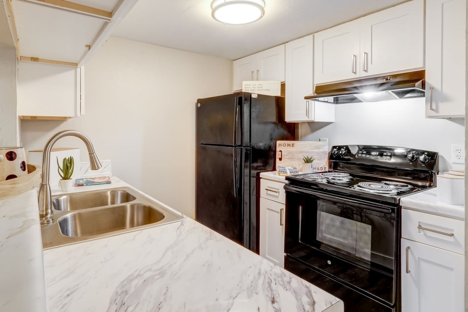 Modern kitchen with granite counter tops at Grove at Stonebrook Apartments & Townhomes in Norcross, Georgia