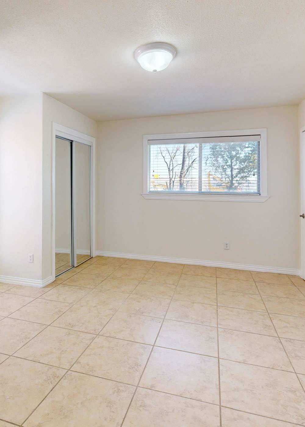 Bedroom with walk-in closets at Tucasa Townhomes in Irving, Texas