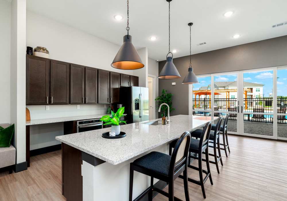 New kitchen with granite countertops and multiple seating at Redwood in San Marcos, Texas
