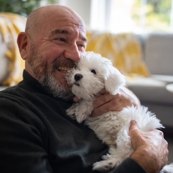 A resident holding his dog at Attain at Quarterpath, Williamsburg, Virginia