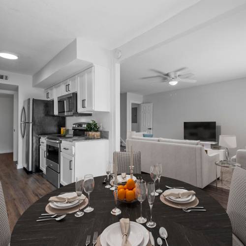 Well-organized dining table with open kitchen at The Alista Apartments in Dallas, Texas, 