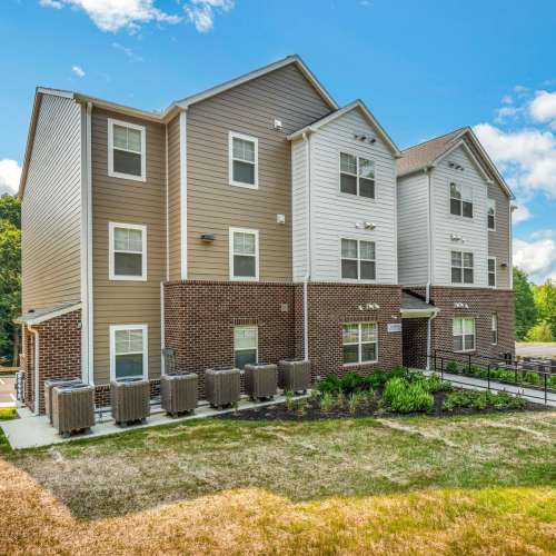Exterior view of white and tan building at Magnolia Greene in Lavale, Maryland