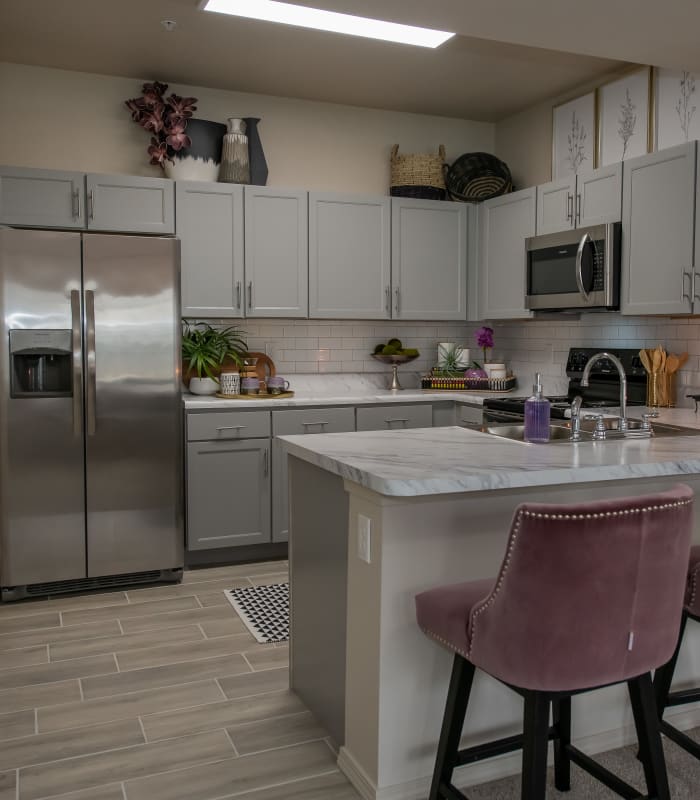 Kitchen with granite countertops at Bend at New Road Apartments in Waco, Texas