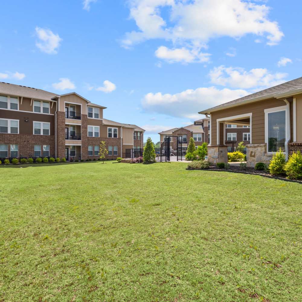 Community exterior with green lawn at Deer Park in Athens, Texas