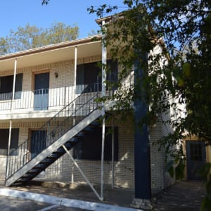 Exterior and front entrances of the apartments at Hampton Village in DeSoto, Texas