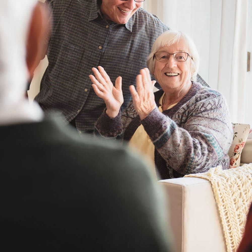 Resident laughing and clapping at Anthology of Town and Country in Town and Country, Missouri