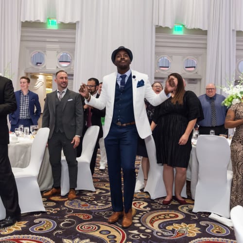 Teammate dancing a jig after receiving an award at a holiday party ceremony at Campus Life & Style in Austin, Texas