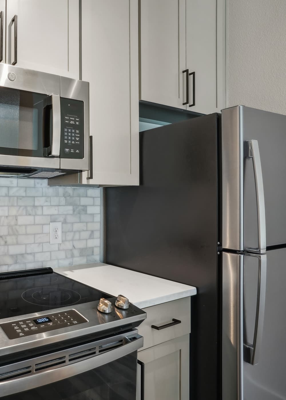 Kitchen with stainless-steel appliances at Halston in Dallas, Texas