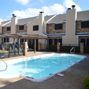 Resident swimming pool and apartments at Highland Oaks in Duncanville, Texas