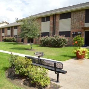 Park bench, grilling station, and walking path at Parkway Villas in Grand Prairie, Texas