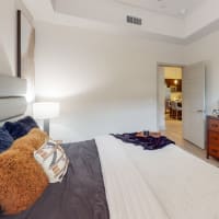 Modern furnishings in a model apartment's primary bedroom at Bellrock Bishop Arts in Dallas, Texas
