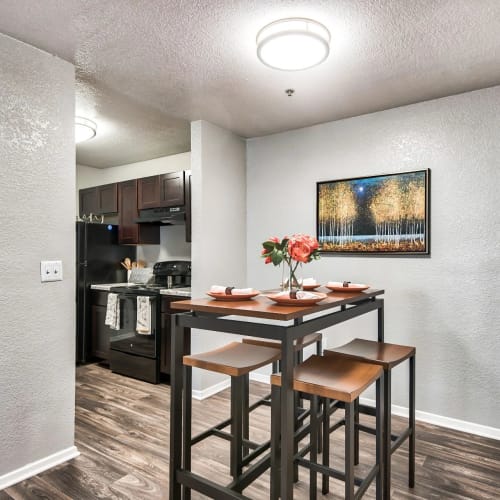 A set dining table next to the kitchen in an apartment at Reserve at Stillwater in Durham, North Carolina