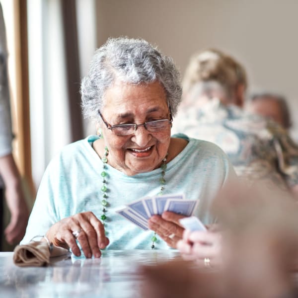 A resident playing a card game at Pacifica Senior Living Menifee in Sun City, California.