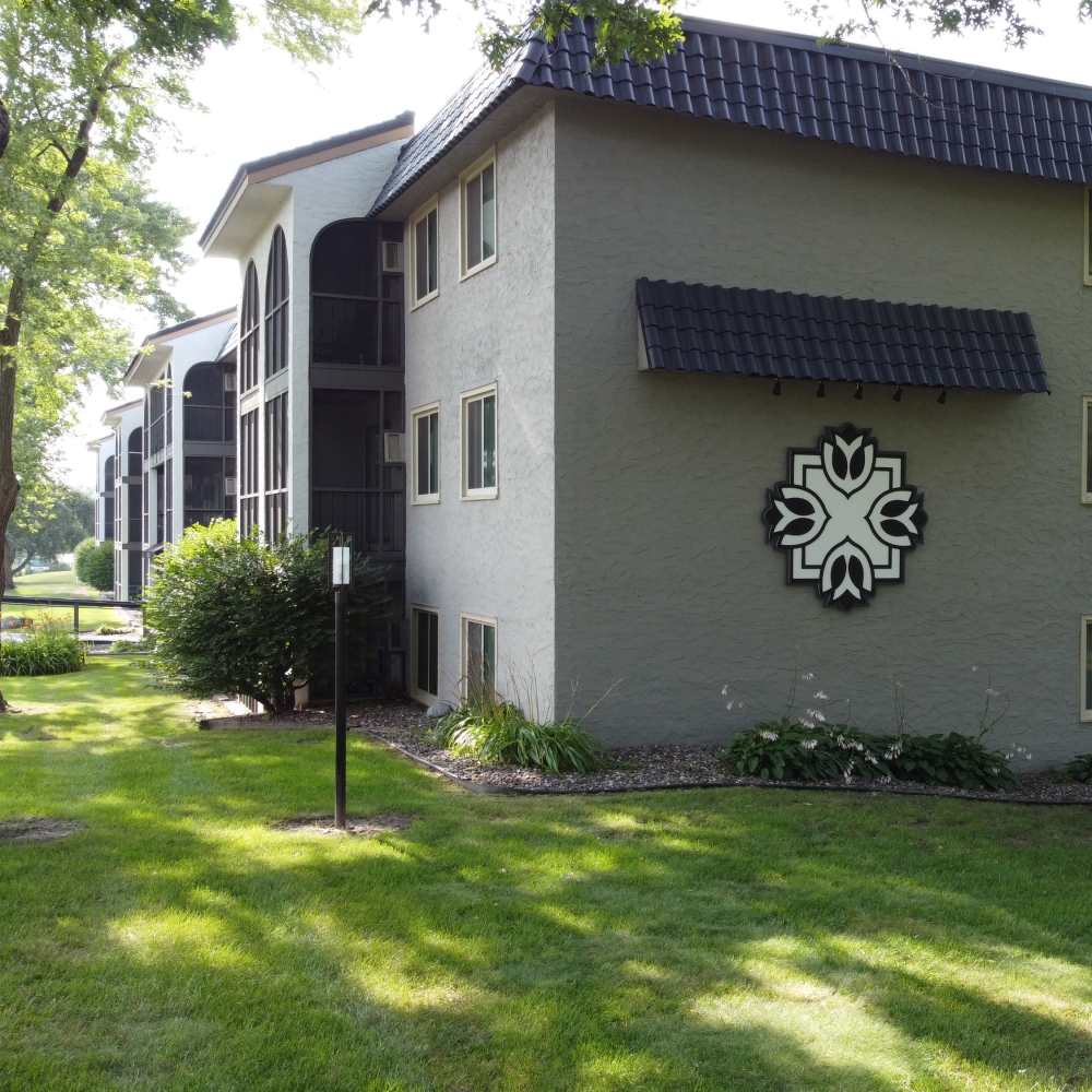 Lush green view of the apartments at Morada in Crystal, Minnesota