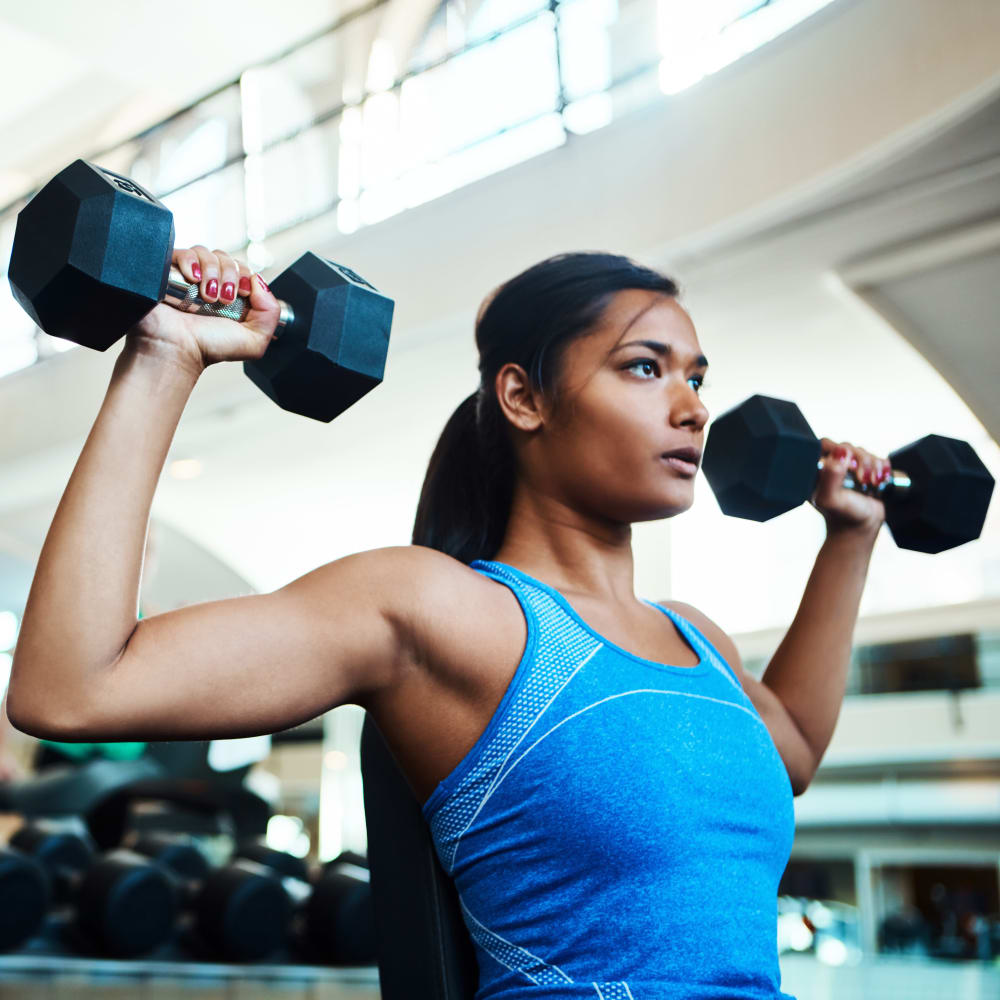 Resident lifting weights at The Presidio in Pensacola, Florida