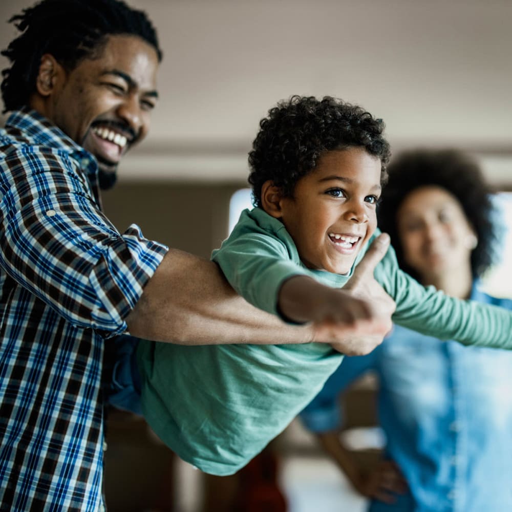 Family playing together in their apartment at Oaks Braemar in Edina, Minnesota