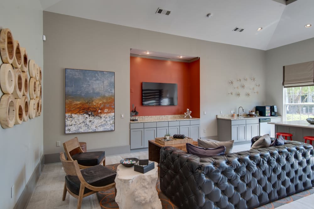 Resident clubhouse with black leather couches at Legacy at Meridian in Durham, North Carolina