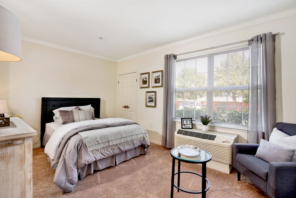 Resident apartment bedroom with bed and furnishings at Kirkwood Orange in Orange, California