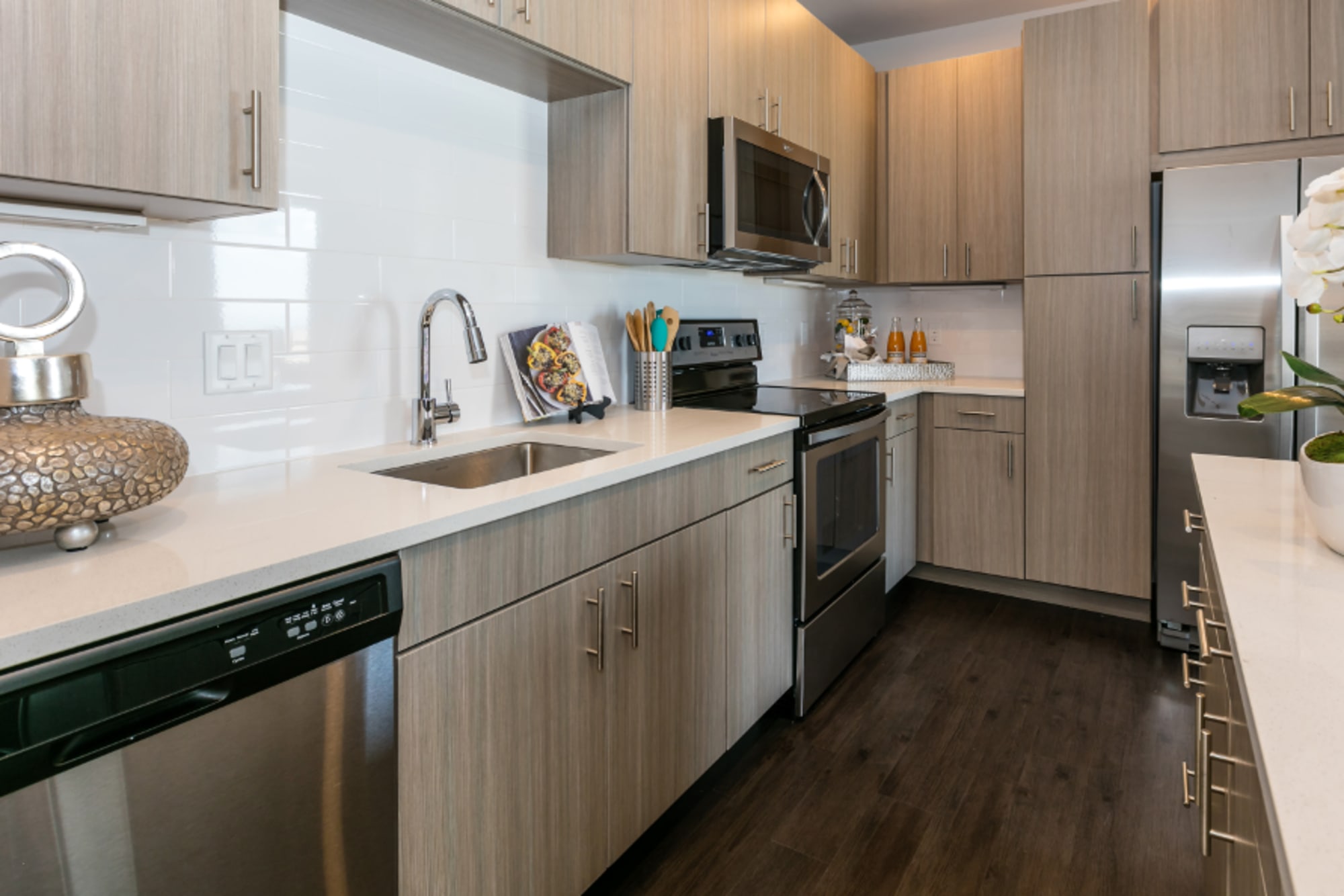 Tile backsplash and cream-colored cabinetry at Strata Apartments in Denver, Colorado
