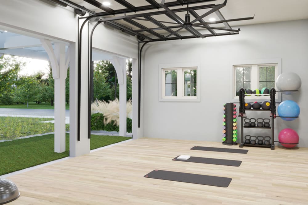 Yoga and fitness studio with roll-up doors opening onto the lawn at Primrose at Santa Rosa Beach in Santa Rosa Beach, Florida