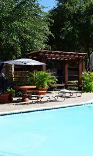 Swimming pool and poolside pergola and picnic tables at River Ranch in Sherman, Texas