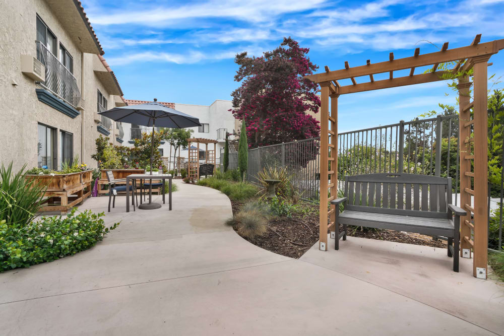 Beautiful landscaping and outdoor furniture along walkways at The Montera in La Mesa, California