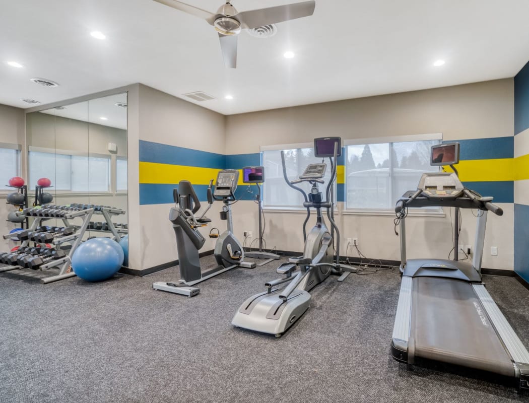 Resident working on in the fitness center at Woodspring Apartments in Tigard, Oregon