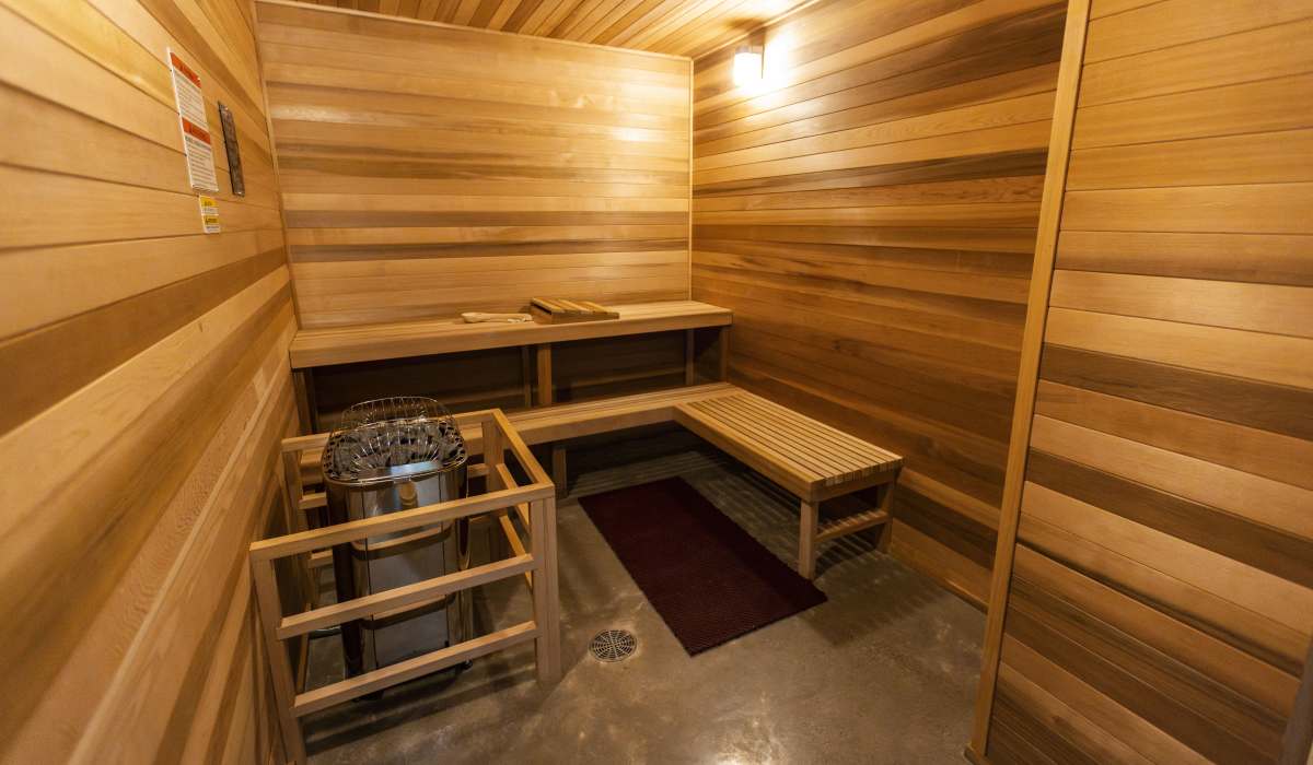 Wood-paneled sauna room with bench seating at Brookland Apartments in Portland, Oregon