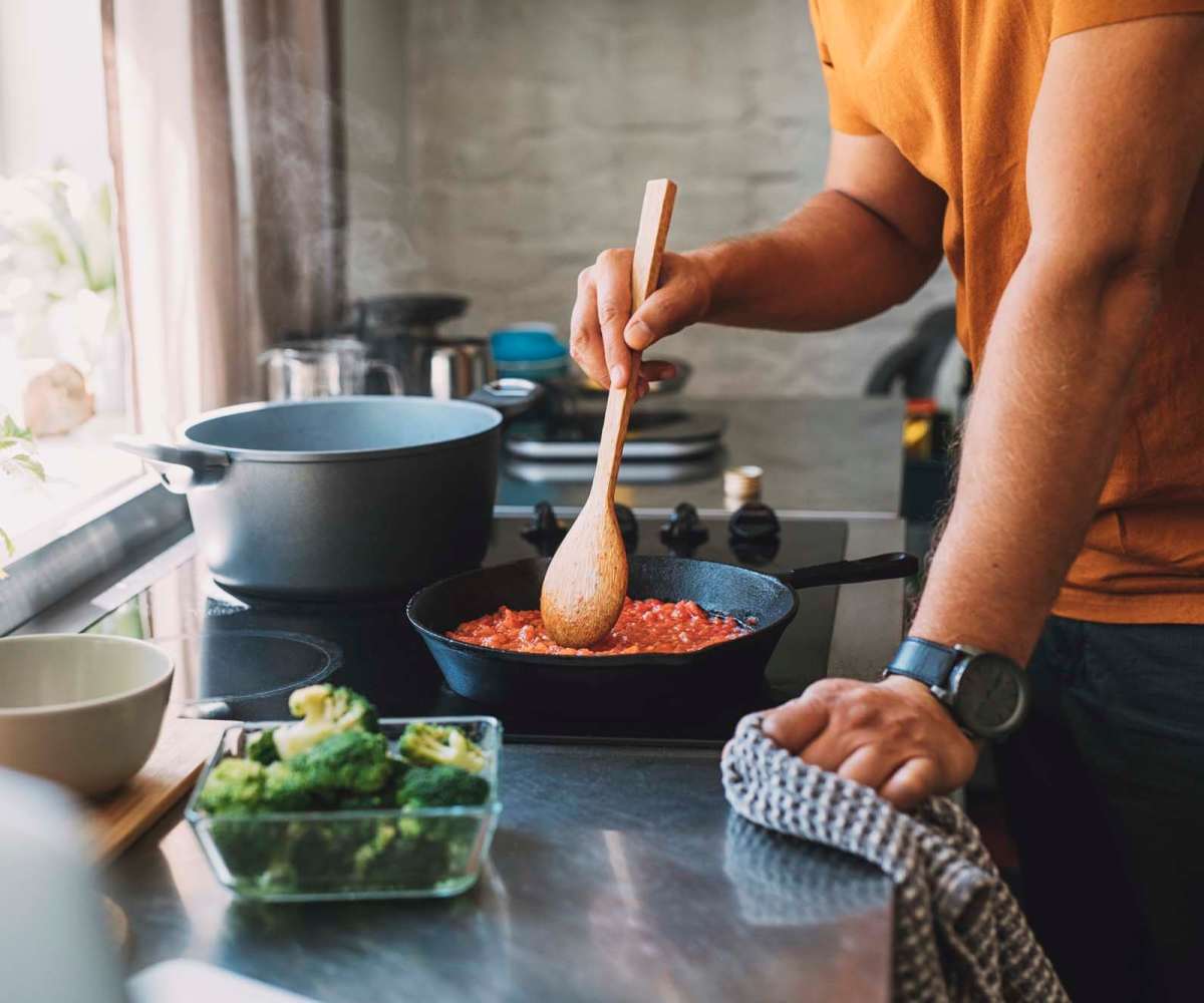 Resident cooking on an electric stove at The Janson in Del Valle, Texas