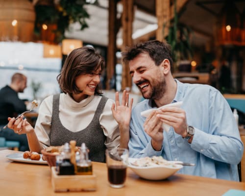 Residents sharing a meal together and laughing near South Meadows in Rome, Georgia