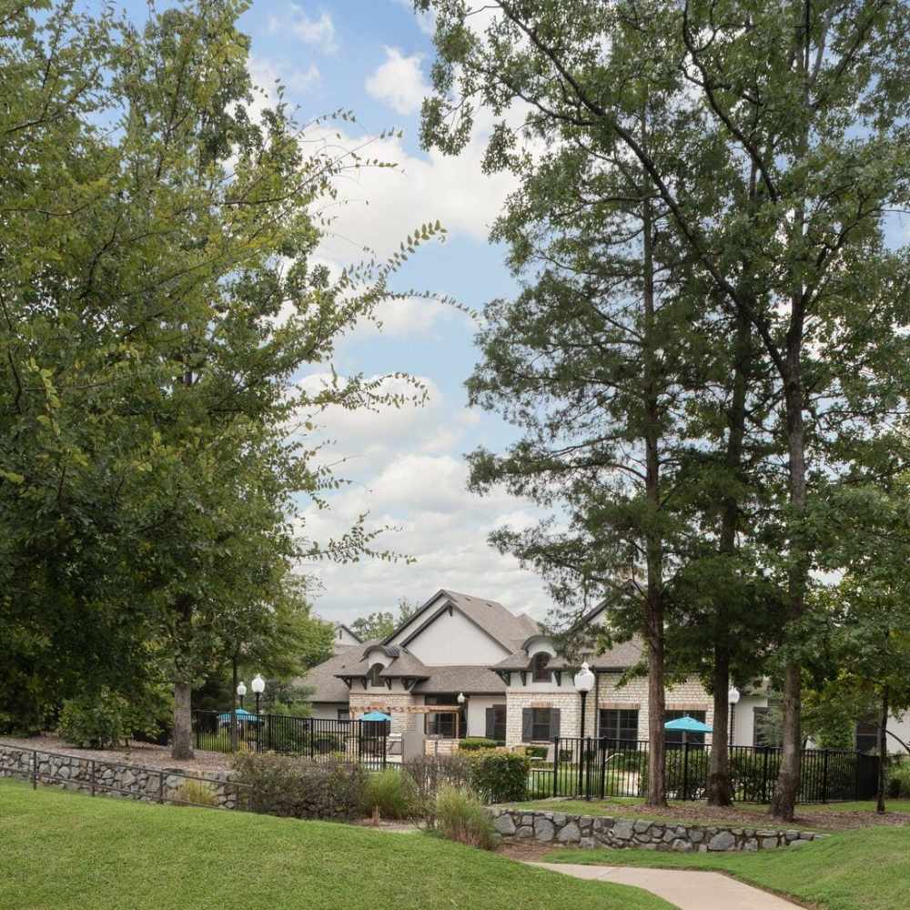 Exterior view of community surrounded by greenery at Stonebridge at the Ranch Apartments in Little Rock, Arkansas