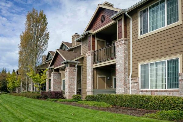 A two story apartment building with well maintained yard at The Grove at Orenco Station in Hillsboro, Oregon