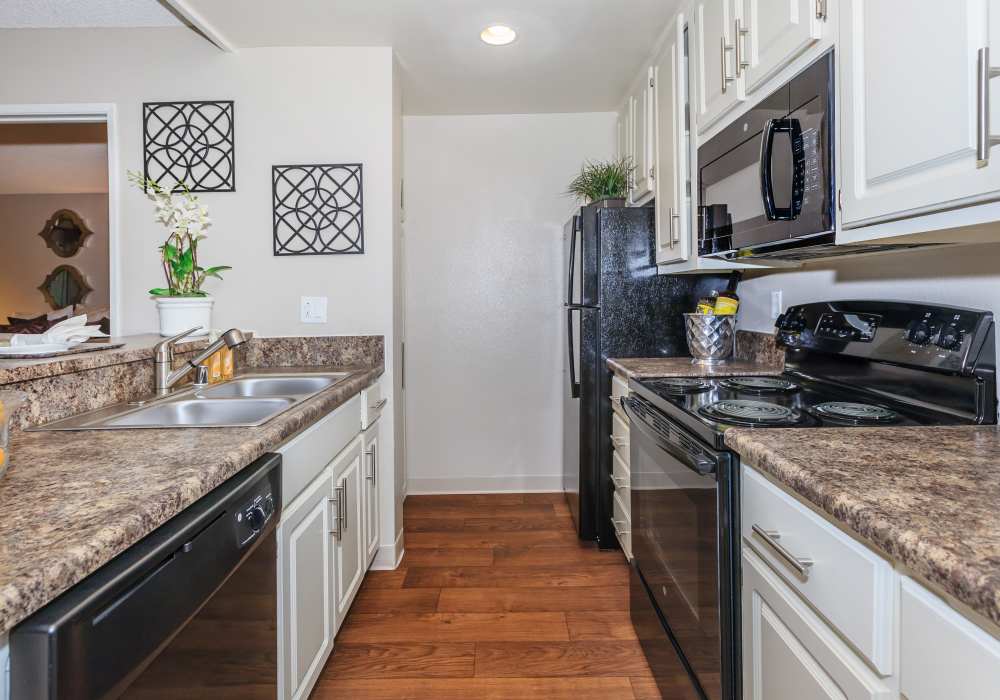 Well-furnished kitchen with cabinets at Parcwood Apartments in Corona, California