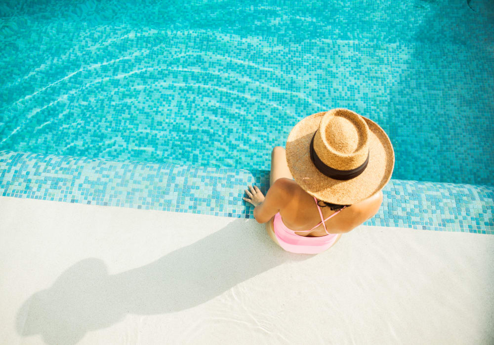 Resident relaxing poolside at Sofi Warner Center in Woodland Hills, California