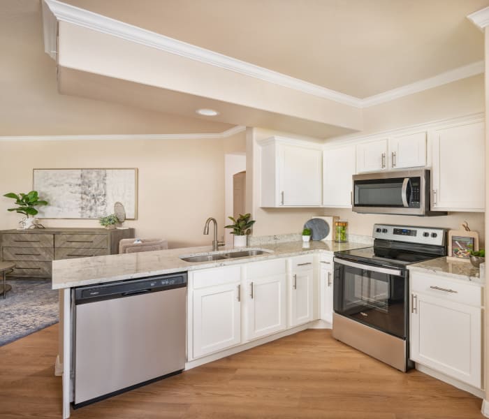 Spacious kitchen with white cabinets an stainless steel appliances at Villas on Hampton Avenue