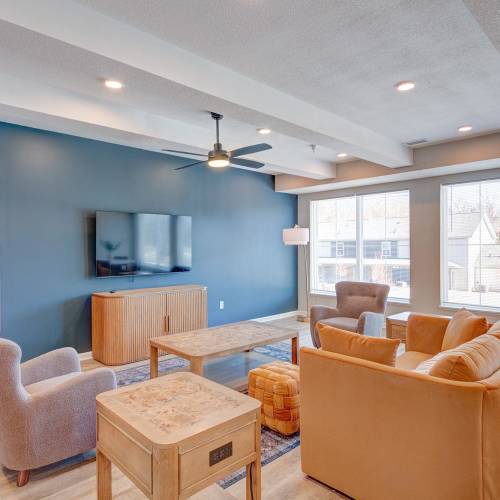 Community lounge area with wall-mounted TV at Stanley Terrace in Plainfield, Indiana