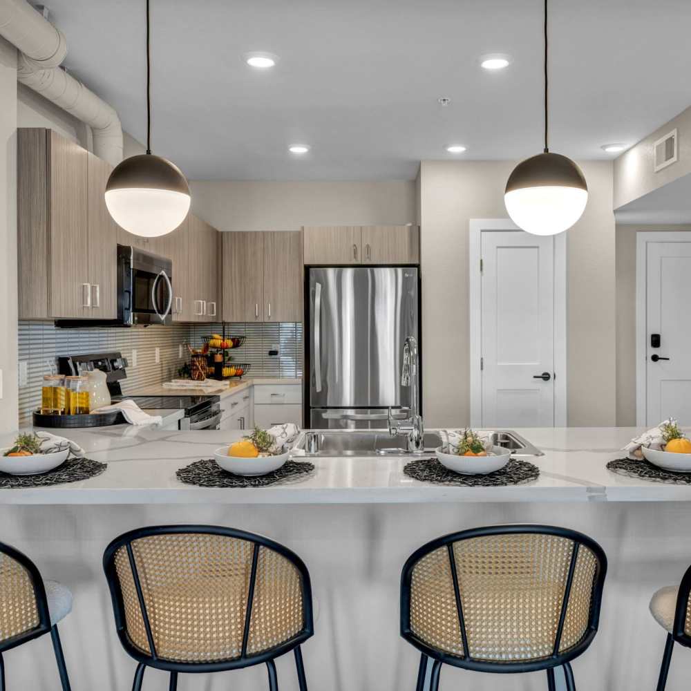 Living room and kitchen bar at Stone Village Apartments in Reno, Nevada
