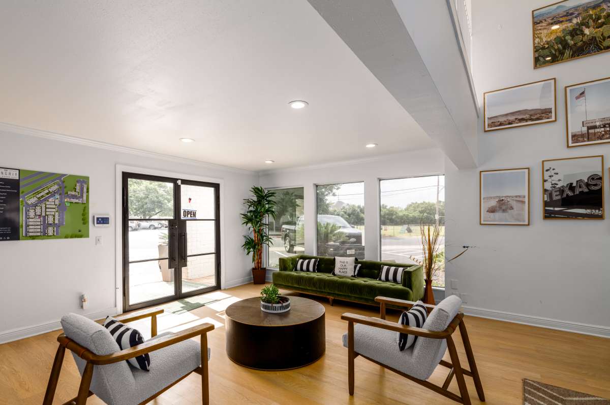 Inviting lobby featuring modern furnishings and large windows at Sangria Park in Austin, Texas.