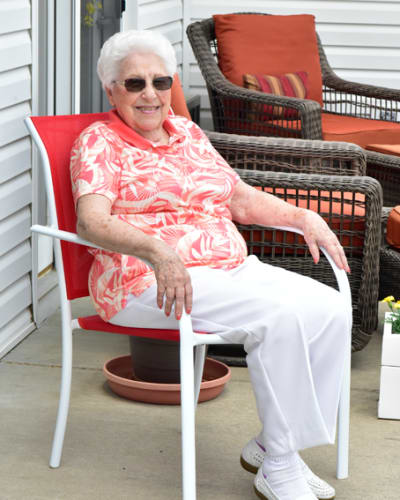 Resident sitting outside at Garden Place Red Bud in Red Bud, Illinois.